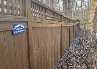Wooden fence along a wooded path