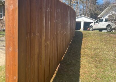 Tall wooden fence casting a shadow