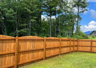 Wooden fence surrounding green landscape