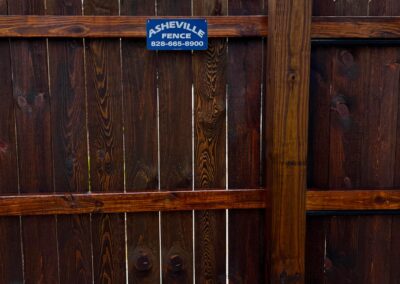Wooden fence with contact sign