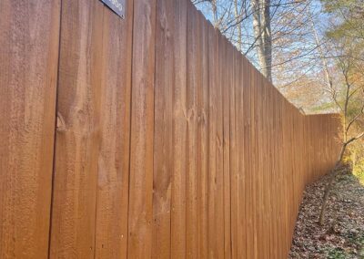 Wooden fence along a wooded area