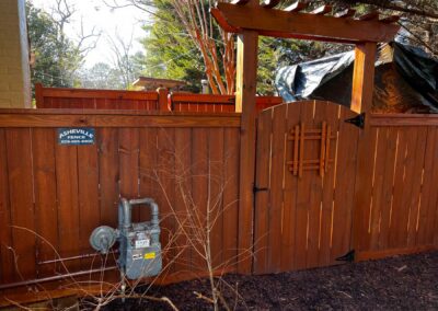 Wooden gate with gas meter nearby