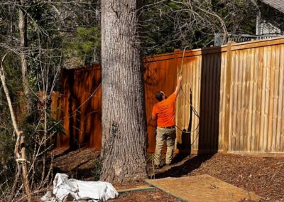 Person working near wooden fence