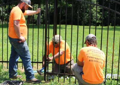 Worker installing a custom aluminum gate