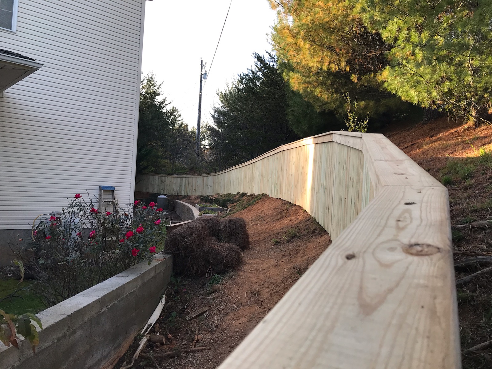 New wood privacy fence following a sloped hillside in Asheville NC