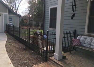 Black fence surrounding a yard area.