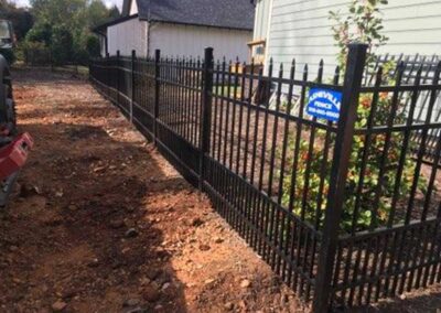 Black aluminum fence with landscaping