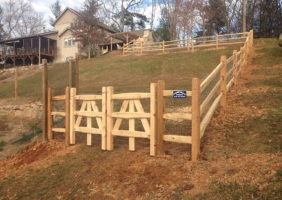 Wooden split rail fence on hillside